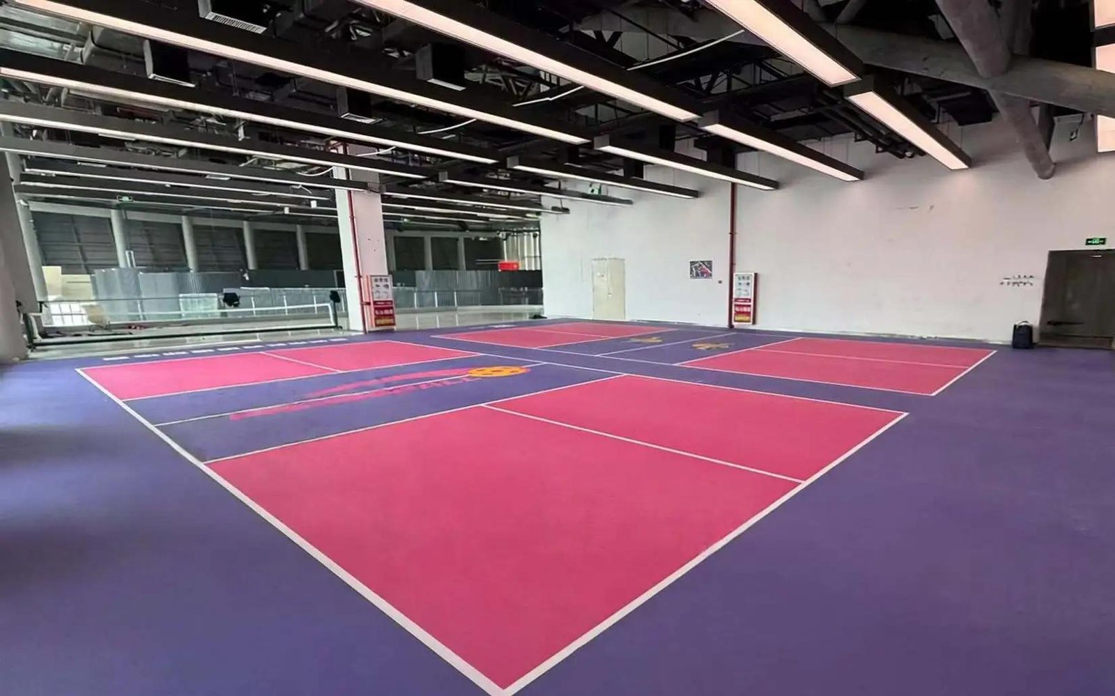 Cross-section of a fiberglass-reinforced PVC sports flooring construction